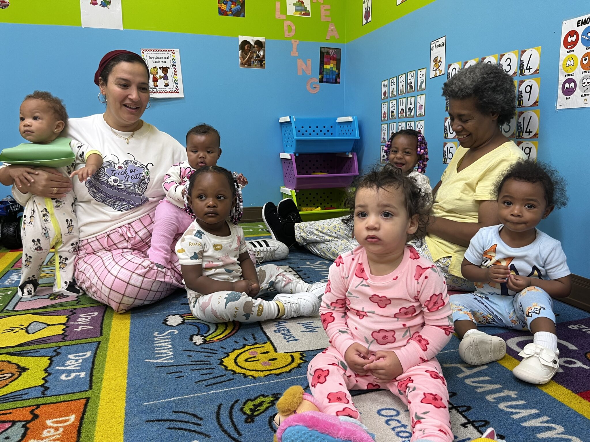 Toddler 1 students with teachers in pajamas.