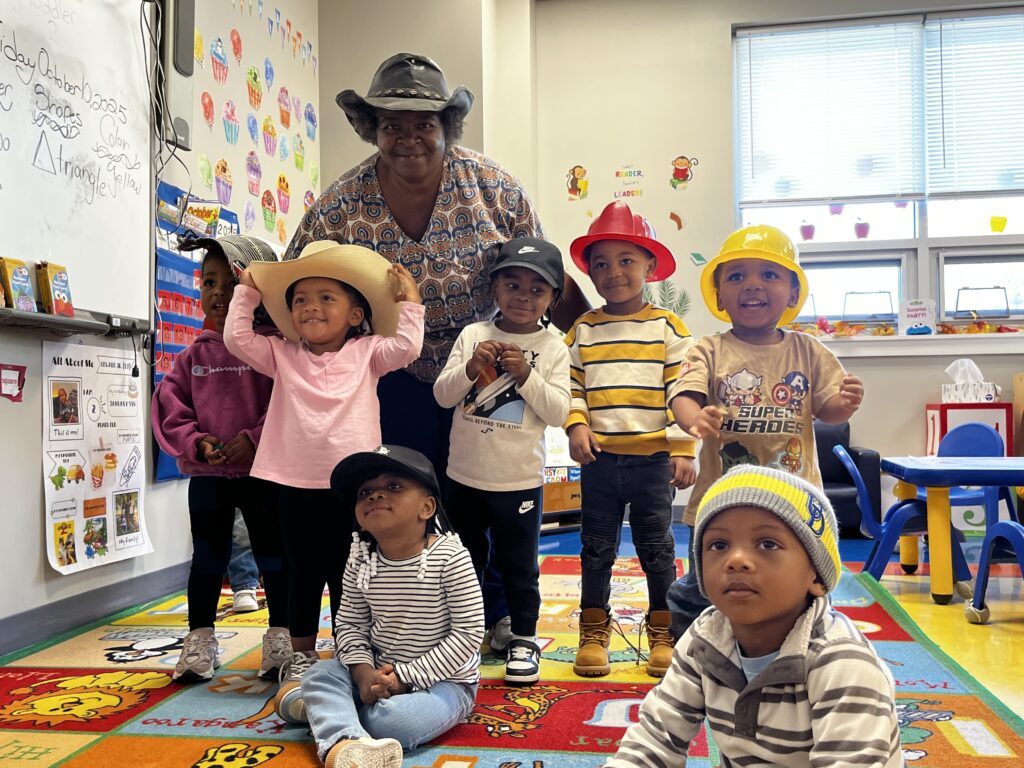 Ms Rachell inside Toddler 2 classroom with her students.